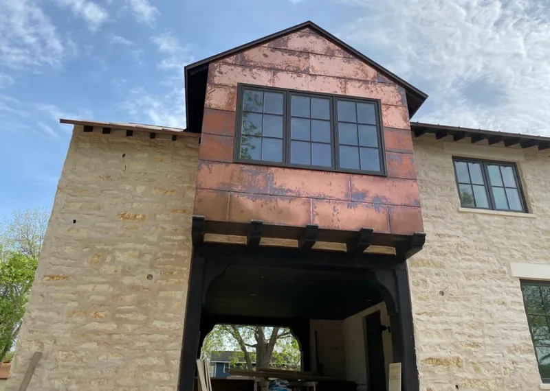 Copper metal panel facade on a stone building for Roof Repair in Westlake